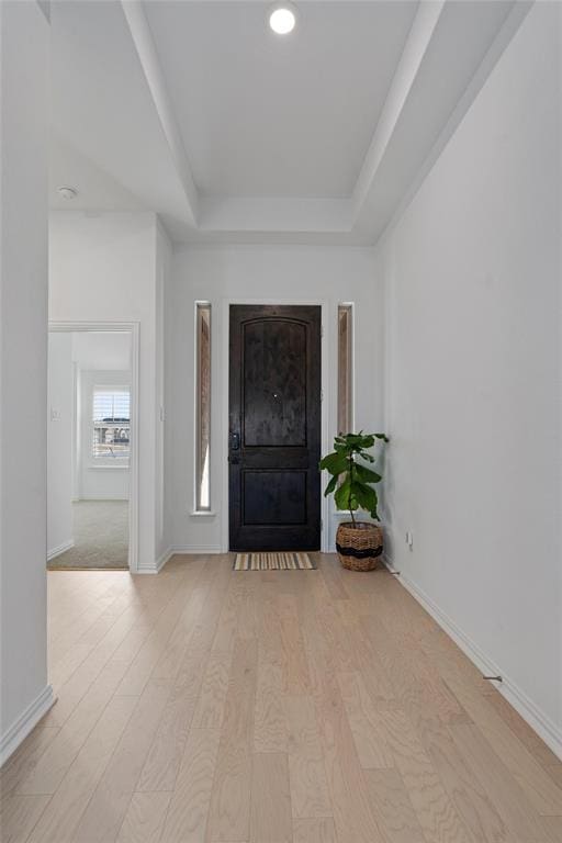 200 Ottaviano Way, Hutto, TX 78634 - foyer entrance featuring a tray ceiling, light wood-style flooring, baseboards, and recessed lighting