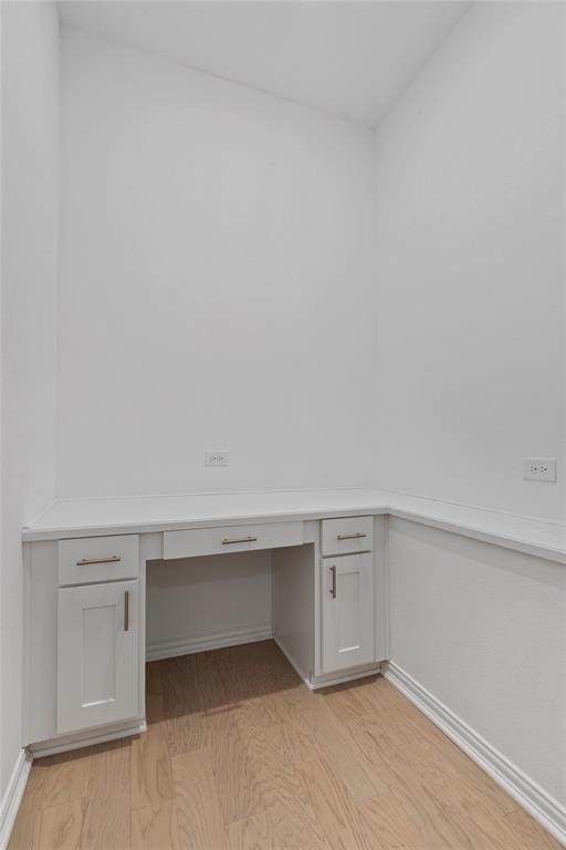 200 Ottaviano Way, Hutto, TX 78634 - unfurnished office featuring built in desk, light wood-style floors, and baseboards
