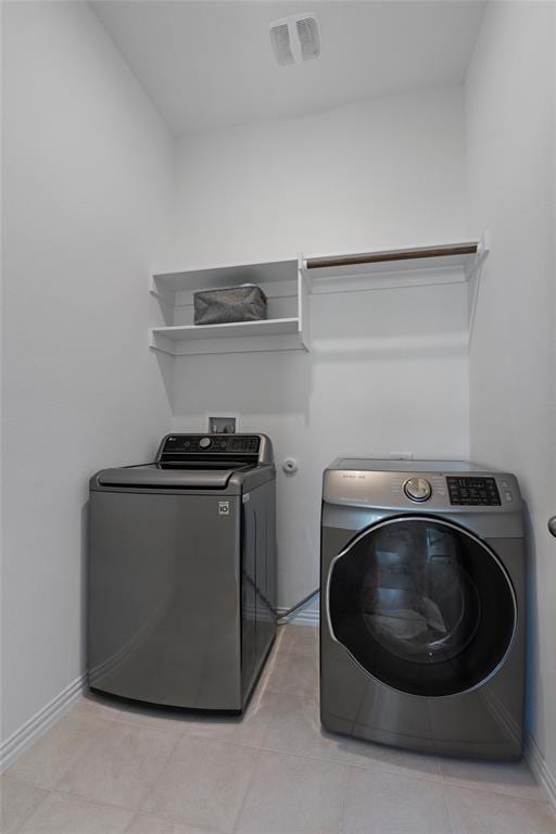 200 Ottaviano Way, Hutto, TX 78634 - laundry area featuring independent washer and dryer, baseboards, and light tile patterned flooring