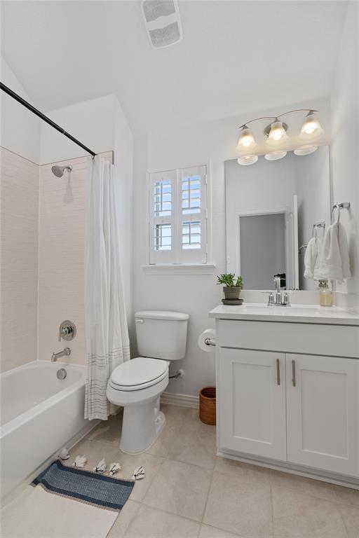 200 Ottaviano Way, Hutto, TX 78634 - full bath with toilet, vanity, tile patterned floors, shower / tub combo with curtain, and baseboards