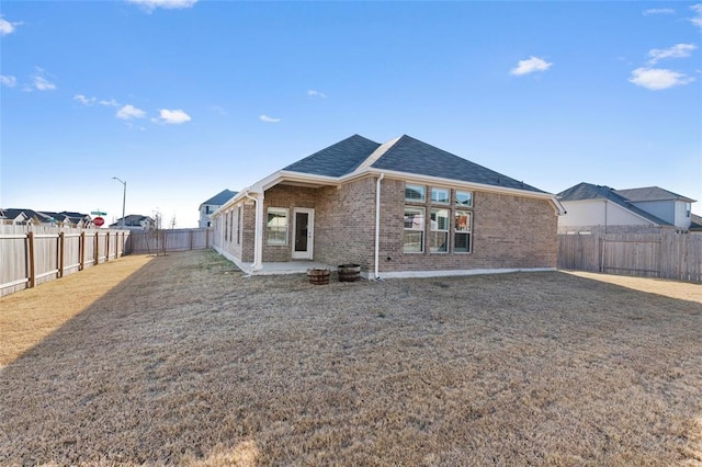 200 Ottaviano Way, Hutto, TX 78634 - rear view of property featuring brick siding, roof with shingles, and a patio area