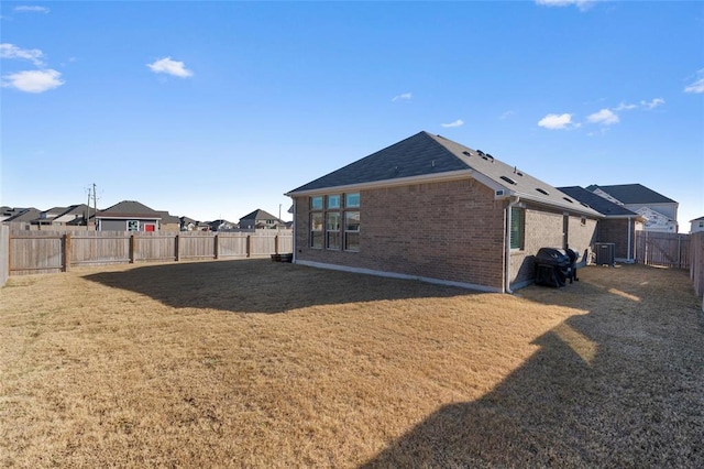 200 Ottaviano Way, Hutto, TX 78634 - rear view of property featuring central AC unit, brick siding, and a shingled roof