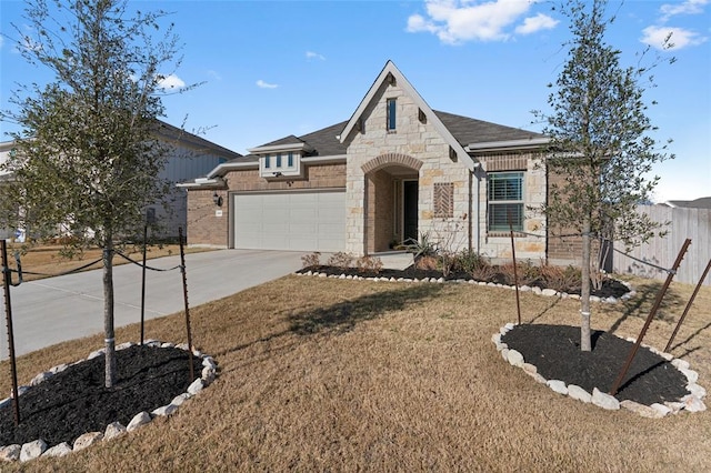200 Ottaviano Way, Hutto, TX 78634 - french country home with stone siding, an attached garage, driveway, and brick siding