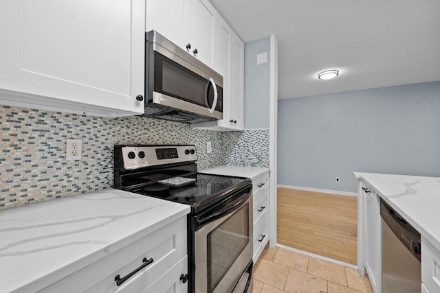 3204 Menchaca Rd Unit 405, Austin, TX 78704 - kitchen featuring stainless steel appliances, white cabinetry, tasteful backsplash, and light stone counters