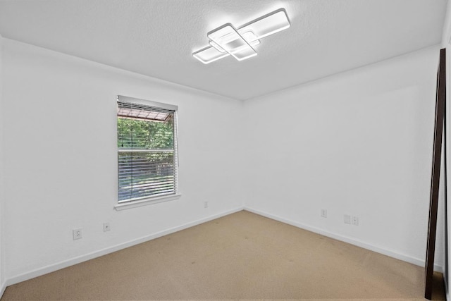 3204 Menchaca Rd Unit 405, Austin, TX 78704 - carpeted spare room featuring a textured ceiling and baseboards
