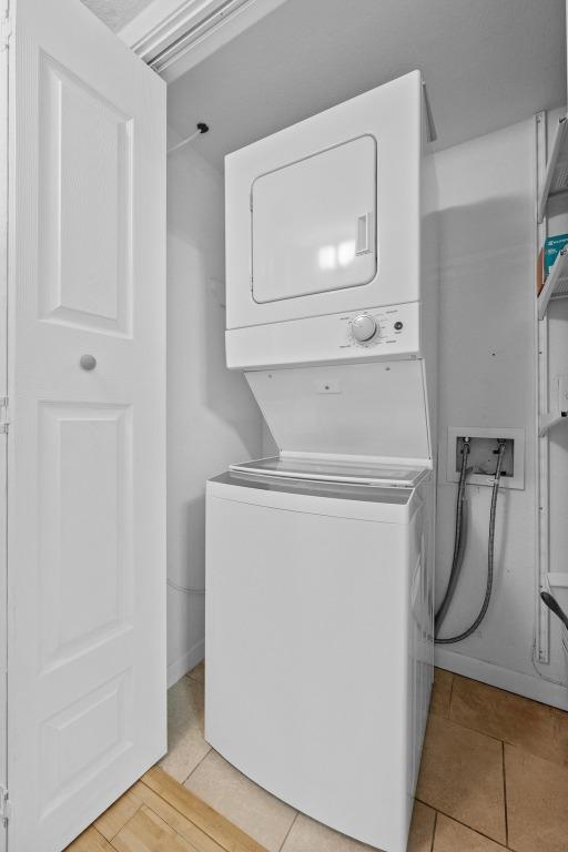 3204 Menchaca Rd Unit 405, Austin, TX 78704 - laundry room featuring stacked washer / drying machine and light tile patterned floors