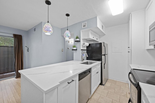 3204 Menchaca Rd Unit 405, Austin, TX 78704 - kitchen with stainless steel appliances, a peninsula, white cabinets, pendant lighting, and light stone counters