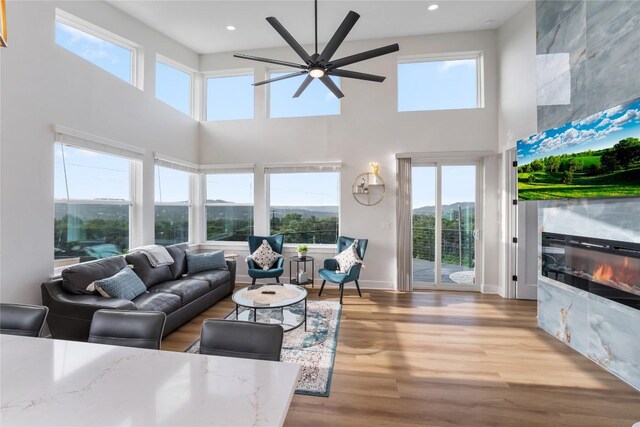 11204 Oak St, Jonestown, TX 78645 - living area with a towering ceiling, healthy amount of natural light, a ceiling fan, wood finished floors, and recessed lighting