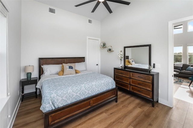 11204 Oak St, Jonestown, TX 78645 - bedroom with high vaulted ceiling, wood finished floors, ceiling fan, and baseboards