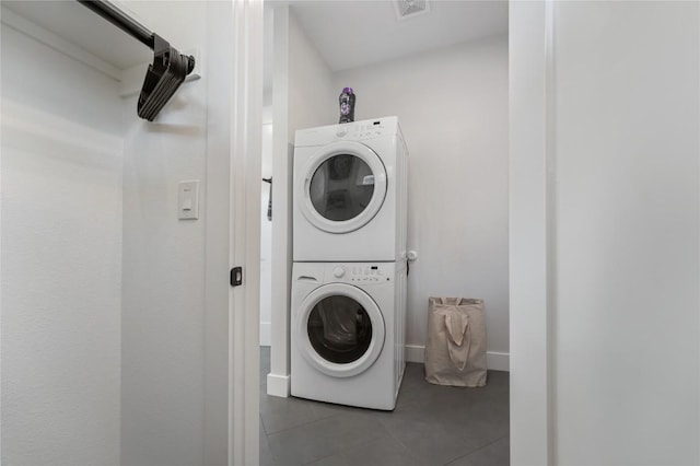 11204 Oak St, Jonestown, TX 78645 - washroom with stacked washer and clothes dryer, tile patterned floors, and baseboards