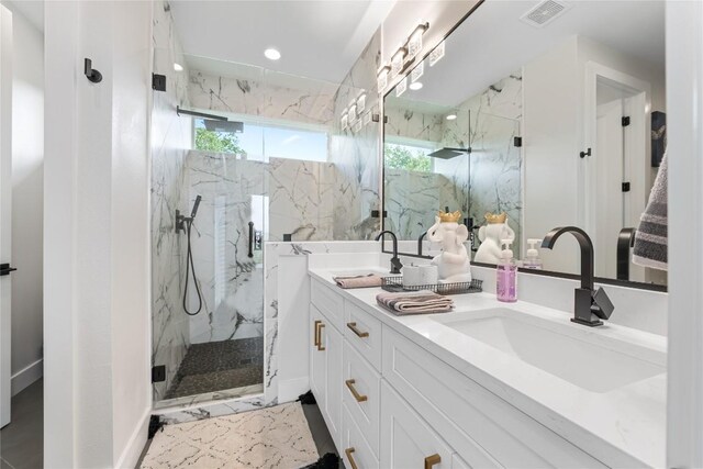 11204 Oak St, Jonestown, TX 78645 - full bath featuring a marble finish shower, double vanity, healthy amount of natural light, and recessed lighting