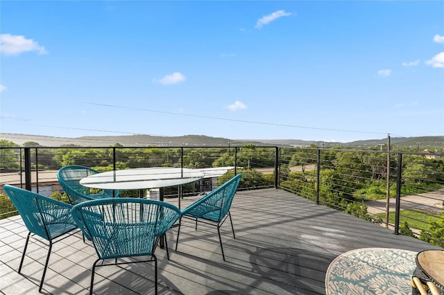 11204 Oak St, Jonestown, TX 78645 - wooden deck featuring a mountain view and outdoor dining area