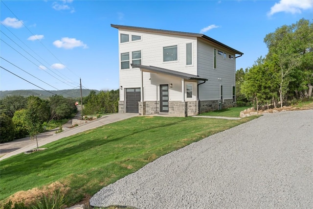 11204 Oak St, Jonestown, TX 78645 - view of front of house featuring stone siding, driveway, a front lawn, and an attached garage