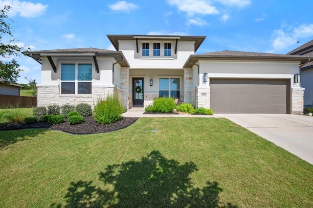 1609 Indian Apple Way, Leander, TX 78641 - prairie-style home with stone siding, stucco siding, driveway, and an attached garage