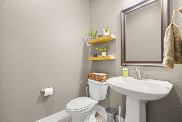 1609 Indian Apple Way, Leander, TX 78641 - half bathroom with toilet, baseboards, tile patterned flooring, and a sink