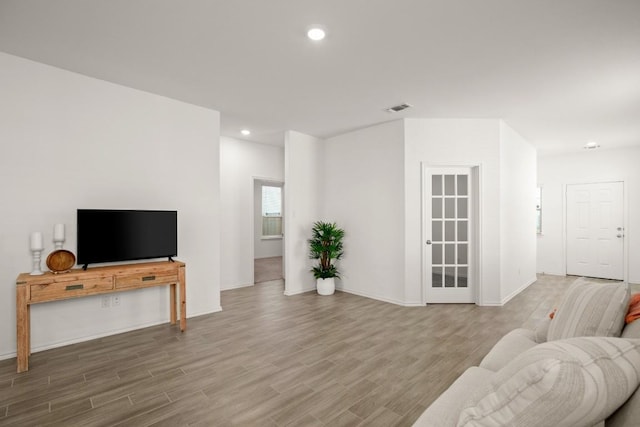 637 Pickrell Loop, Liberty Hill, TX 78642 - living room with wood finished floors, recessed lighting, and baseboards