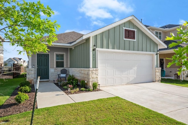 637 Pickrell Loop, Liberty Hill, TX 78642 - view of front of property with board and batten siding, concrete driveway, an attached garage, and stone siding