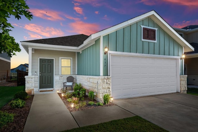 637 Pickrell Loop, Liberty Hill, TX 78642 - view of front of home featuring board and batten siding, stone siding, a garage, roof with shingles, and concrete driveway