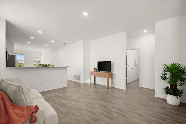 637 Pickrell Loop, Liberty Hill, TX 78642 - living area featuring recessed lighting, wood finished floors, and baseboards