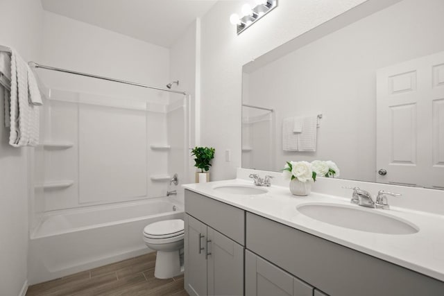 637 Pickrell Loop, Liberty Hill, TX 78642 - bathroom with wood finished floors, toilet, double vanity, and shower / tub combination