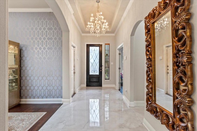 2997 Agave Loop, Round Rock, TX 78681 - foyer featuring arched walkways, a chandelier, marble tiled floors, ornamental molding, and wallpapered walls