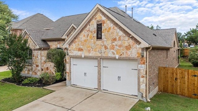 2997 Agave Loop, Round Rock, TX 78681 - french country style house featuring stone siding, a garage, driveway, and a shingled roof