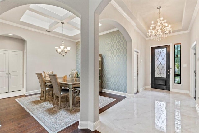2997 Agave Loop, Round Rock, TX 78681 - entryway with a chandelier, arched walkways, ornamental molding, a tray ceiling, and coffered ceiling