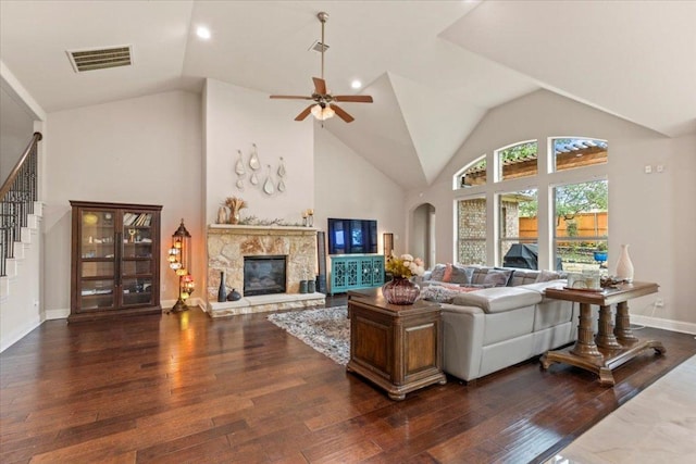 2997 Agave Loop, Round Rock, TX 78681 - living room featuring wood-type flooring, ceiling fan, a fireplace, stairs, and high vaulted ceiling