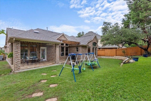 2997 Agave Loop, Round Rock, TX 78681 - rear view of property featuring a fenced backyard, brick siding, a playground, and a patio