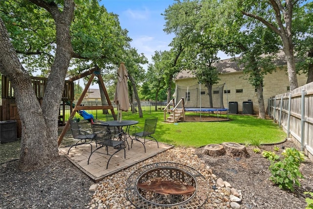 148 Oak Plaza Dr, Georgetown, TX 78628 - view of yard with an outdoor fire pit, a trampoline, cooling unit, and a patio area