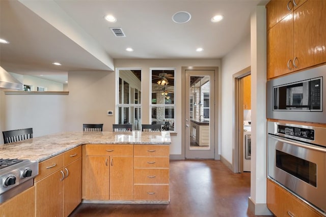 148 Oak Plaza Dr, Georgetown, TX 78628 - kitchen featuring appliances with stainless steel finishes, light stone counters, finished concrete floors, recessed lighting, and baseboards