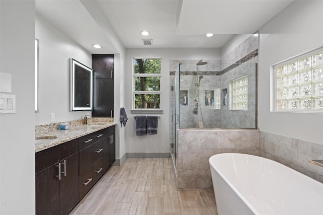 148 Oak Plaza Dr, Georgetown, TX 78628 - bathroom with a freestanding bath, vanity, a shower stall, and recessed lighting
