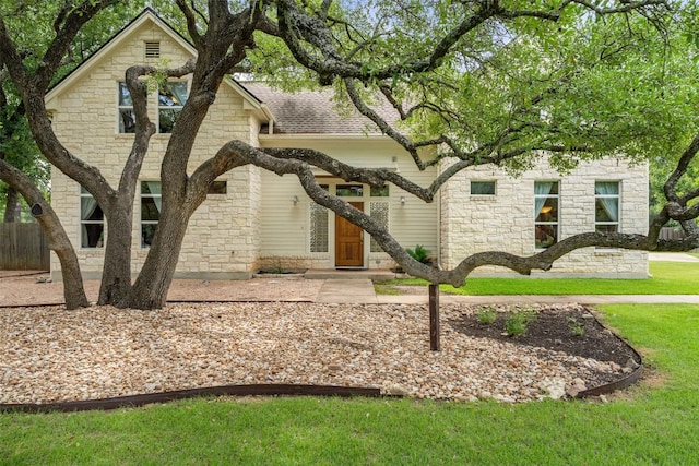 148 Oak Plaza Dr, Georgetown, TX 78628 - view of front facade featuring stone siding and a front lawn