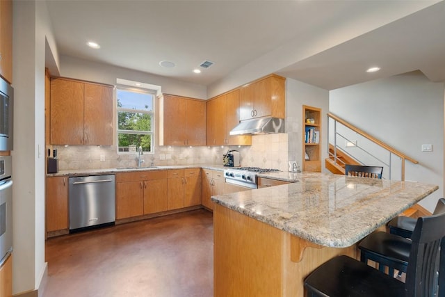 148 Oak Plaza Dr, Georgetown, TX 78628 - kitchen featuring stainless steel dishwasher, range, a peninsula, concrete floors, and a sink