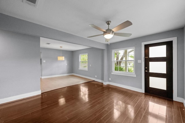 5601 Samuel Huston Ave, Austin, TX 78721 - entryway with baseboards, wood finished floors, and ceiling fan