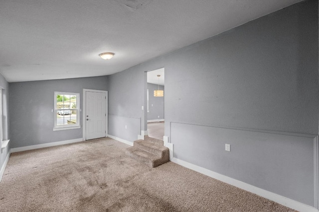 5601 Samuel Huston Ave, Austin, TX 78721 - spare room featuring carpet flooring and lofted ceiling