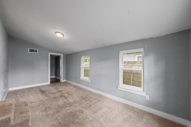 5601 Samuel Huston Ave, Austin, TX 78721 - unfurnished room with vaulted ceiling and carpet flooring