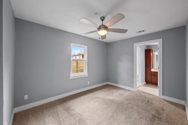 5601 Samuel Huston Ave, Austin, TX 78721 - empty room with light carpet, a ceiling fan, and baseboards