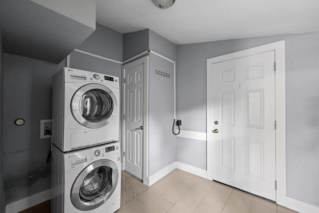 5601 Samuel Huston Ave, Austin, TX 78721 - washroom with stacked washing machine and dryer and baseboards