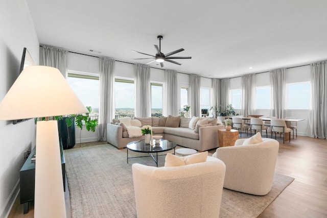 256 Smoke Tree Cir, Dripping Springs, TX 78620 - living room featuring healthy amount of natural light, a ceiling fan, and light wood-style flooring
