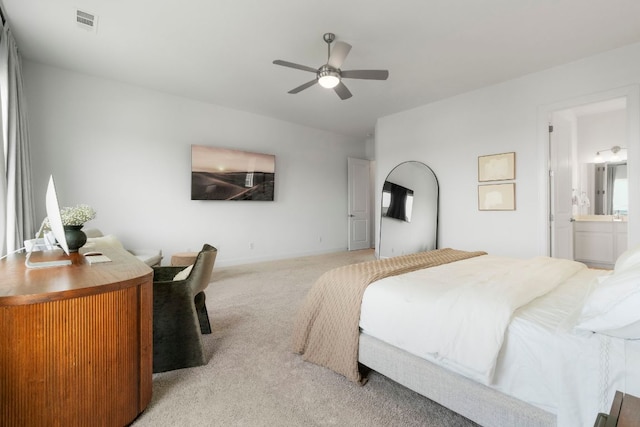 256 Smoke Tree Cir, Dripping Springs, TX 78620 - bedroom featuring light carpet, connected bathroom, ceiling fan, and baseboards