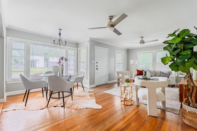 3210 Funston St, Austin, TX 78703 - dining room featuring baseboards, light wood-style floors, a chandelier, ornamental molding, and a ceiling fan