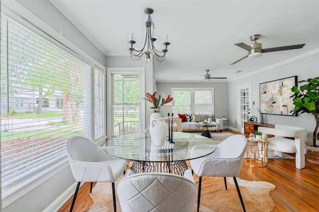 3210 Funston St, Austin, TX 78703 - dining area featuring crown molding, wood finished floors, a chandelier, ceiling fan, and baseboards