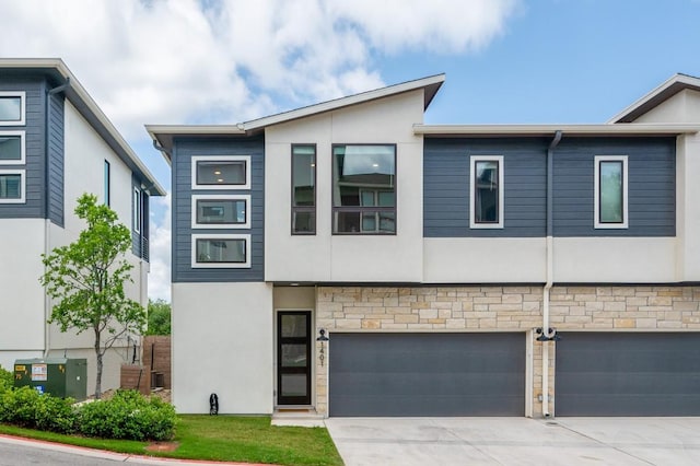 2050 Lohmans Spur Unit 1401, Austin, TX 78734 - view of front of house featuring stucco siding, a garage, driveway, and stone siding