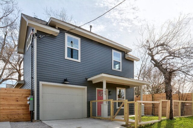 105 Elkhart St Unit 3, Austin, TX 78702 - view of front of house featuring an attached garage, concrete driveway, and a gate