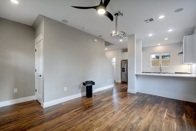 105 Elkhart St Unit 3, Austin, TX 78702 - unfurnished living room featuring dark wood-style floors, a ceiling fan, baseboards, recessed lighting, and a sink