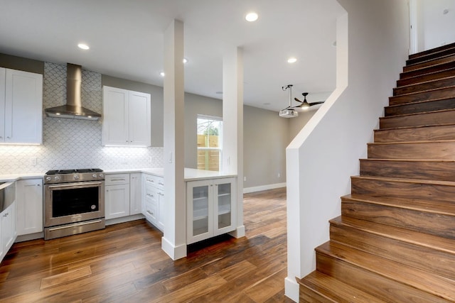 105 Elkhart St Unit 3, Austin, TX 78702 - kitchen featuring stainless steel range with gas stovetop, wall chimney range hood, light countertops, white cabinetry, and recessed lighting