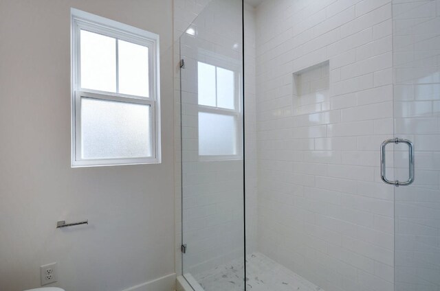 105 Elkhart St Unit 3, Austin, TX 78702 - bathroom featuring a shower stall and baseboards