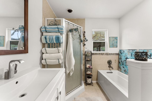 1181 Live Oak Trl, Liberty Hill, TX 78642 - bathroom featuring tile patterned flooring, a bath, a stall shower, vanity, and tile walls