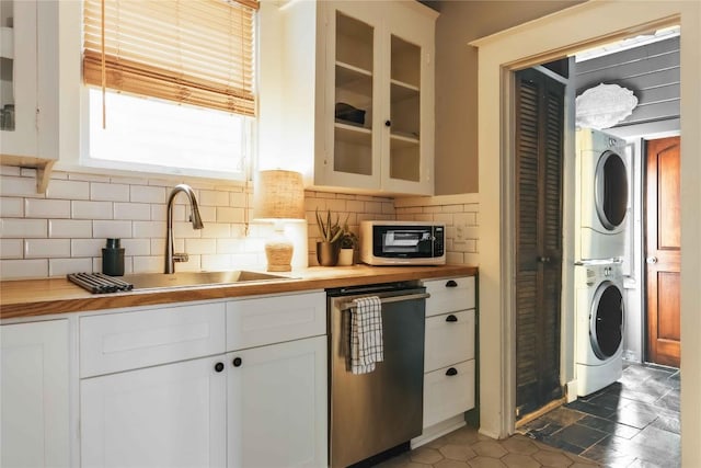 2623 Salado St, Austin, TX 78705 - kitchen with estacked washer and dryer, dishwasher, wood counters, a sink, and decorative backsplash